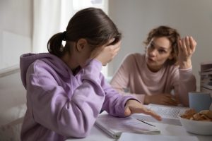 mother upset with daughter trying to learn something